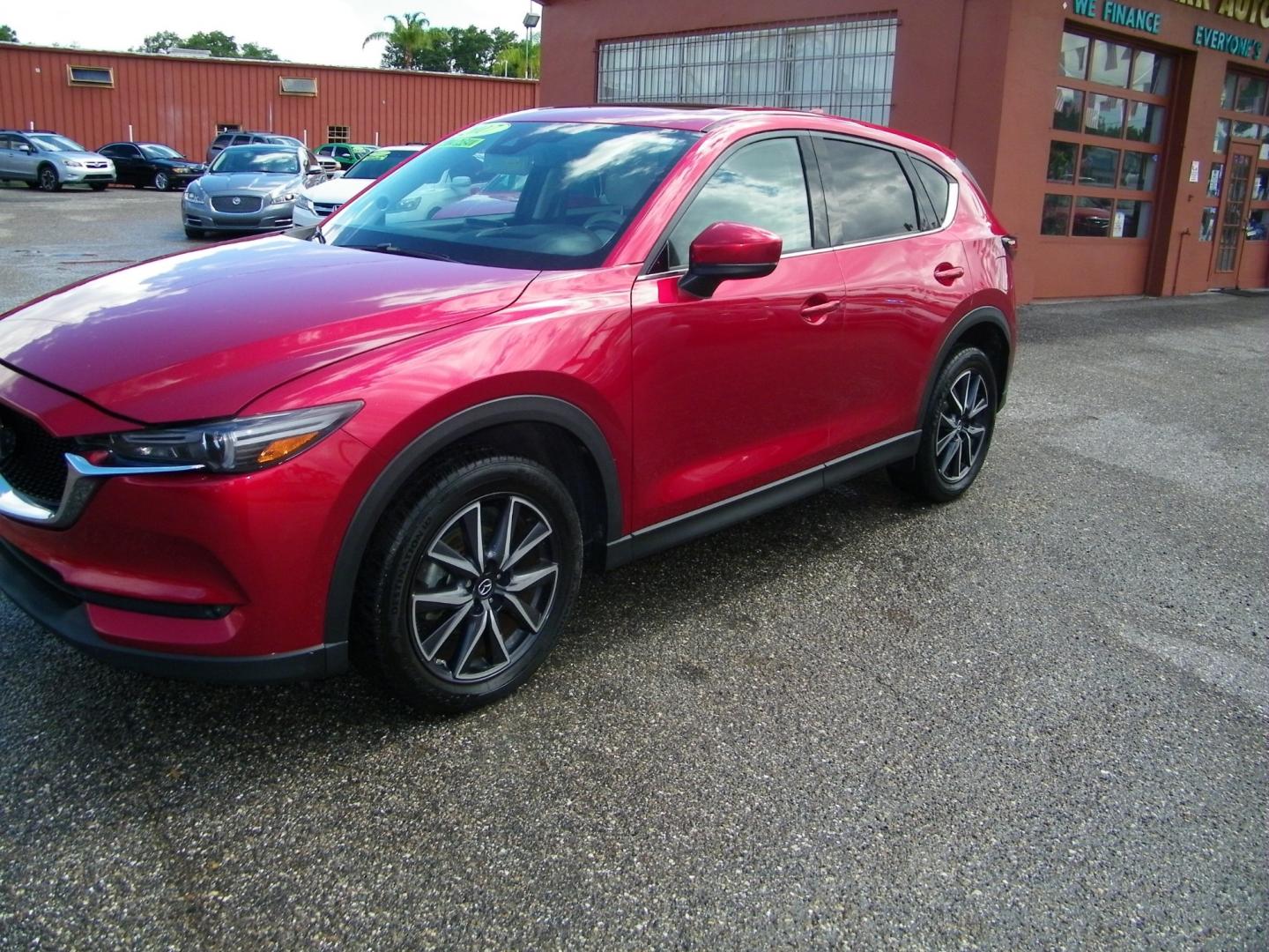 2017 Red /Beige Mazda CX-5 Grand Touring (JM3KFADL4H0) with an 2.5L I4 engine, Automatic transmission, located at 4000 Bee Ridge Road, Sarasota, FL, 34233, (941) 926-0300, 27.298664, -82.489151 - Photo#1