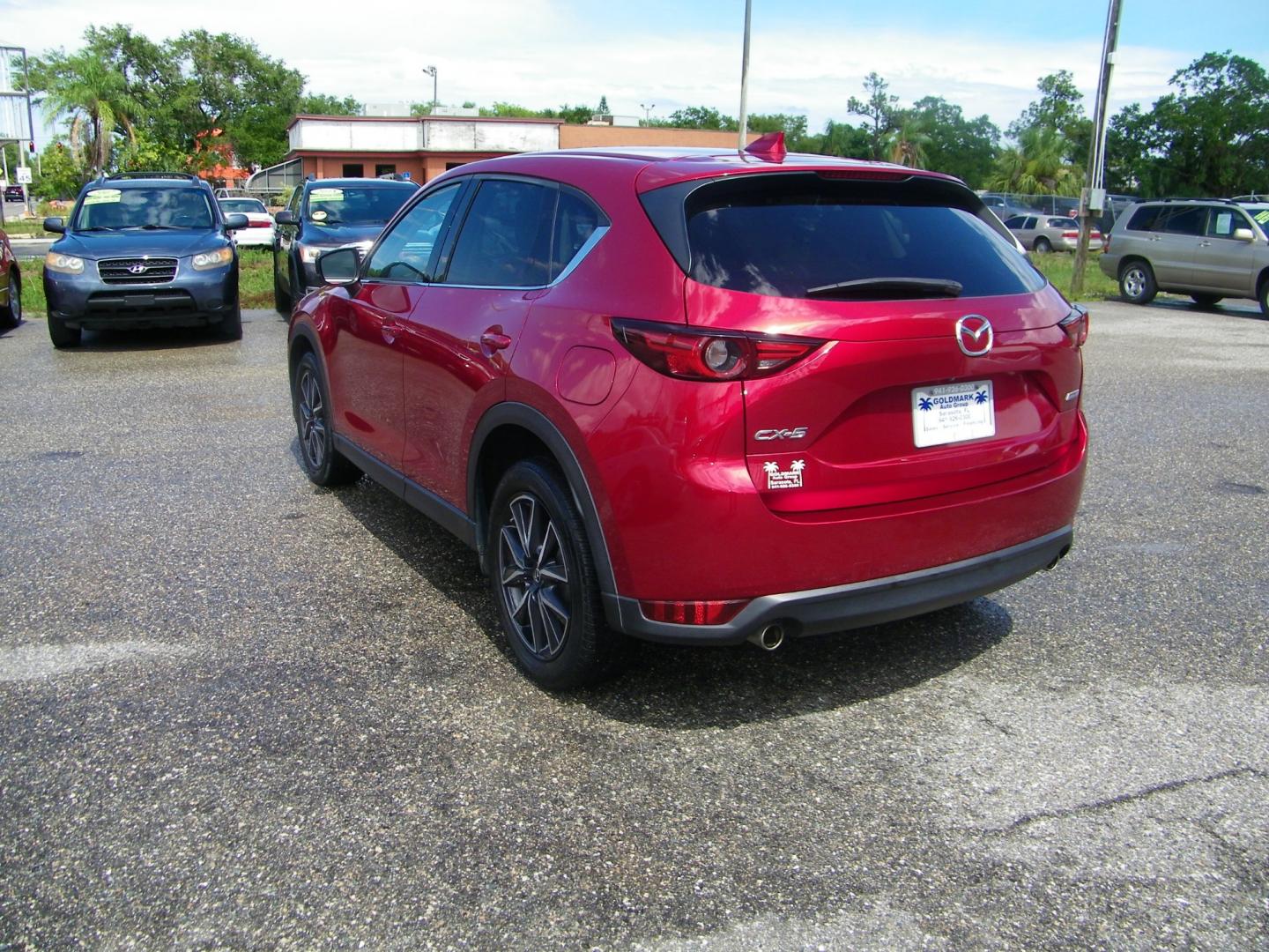 2017 Red /Beige Mazda CX-5 Grand Touring (JM3KFADL4H0) with an 2.5L I4 engine, Automatic transmission, located at 4000 Bee Ridge Road, Sarasota, FL, 34233, (941) 926-0300, 27.298664, -82.489151 - Photo#3